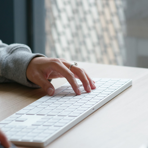 Woman type on desktop computer